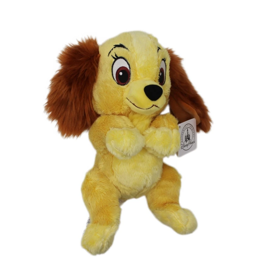 Descubra o Peluche Dama - A Dama e o Vagabundo 25cm. Um peluche Disney macio e encantador, perfeito para crianças, fãs dos clássicos e colecionadores.